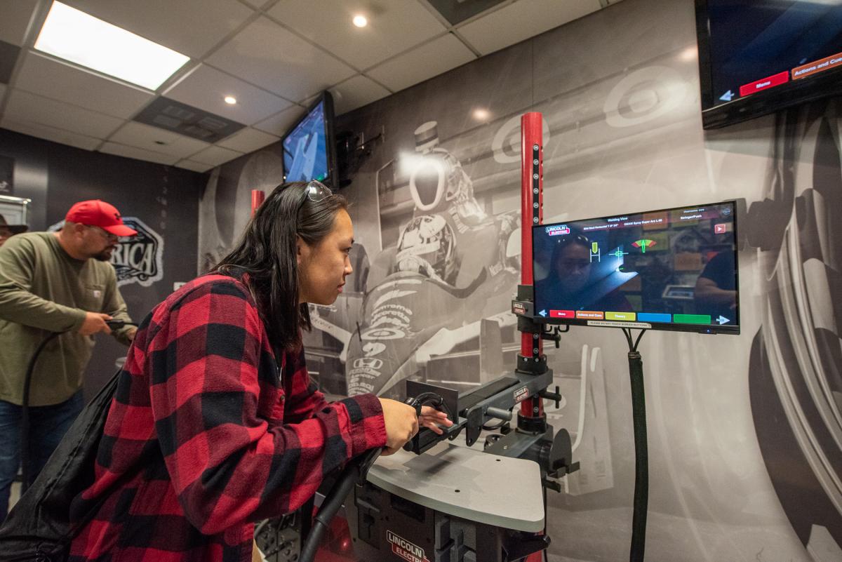 Welding & fabrication engineering technology sophomore Cierra D. Miller tries her hand at gas metal arc welding via the simulator. From Dover, Miller is a Wildcat soccer player, so her Saturday was a busy one!