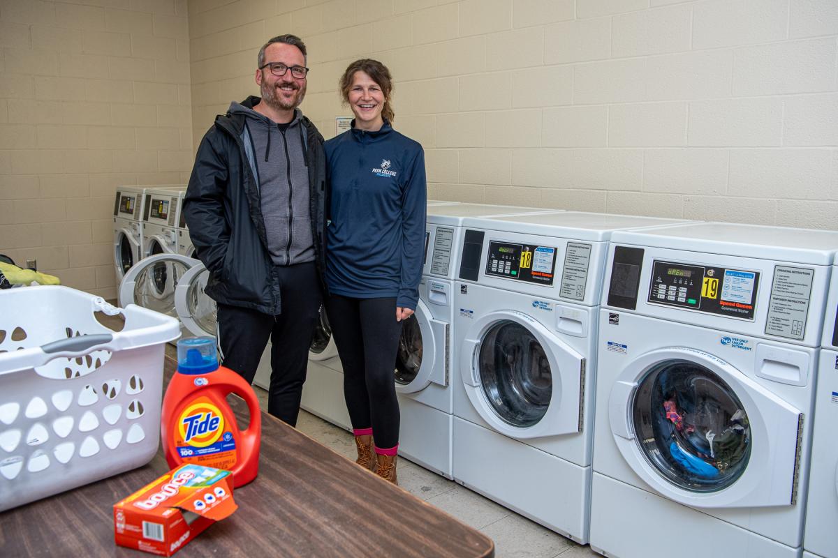 Back where it all begin! Alumni sweethearts and former Village residents Jon W. and Katie L. Mackey first met in this laundry room at The Village in 1997. Katie, assistant director of disability and access resources, recalls that Jon (who she recognized as “the hot guy in her English class”) had “spilled detergent in his laundry basket,” to which she quipped: “This is when you miss your mom the most.” The duo would again live in The Village as a young married couple from 2005-10 when Katie was a Residence L