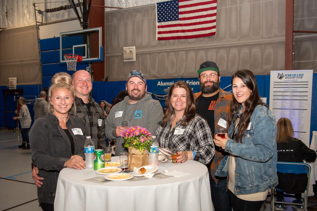 A great reason to gather! From left are Michael D. Ferraiolo, ’11, aviation maintenance technology, and his wife, Melyssa; Clifford T. Early III, ’11, aviation maintenance technology, and his wife, Holly; and Thomas J. Petrusky, ’08, information technology: web & applications development concentration, and his wife, Devin.