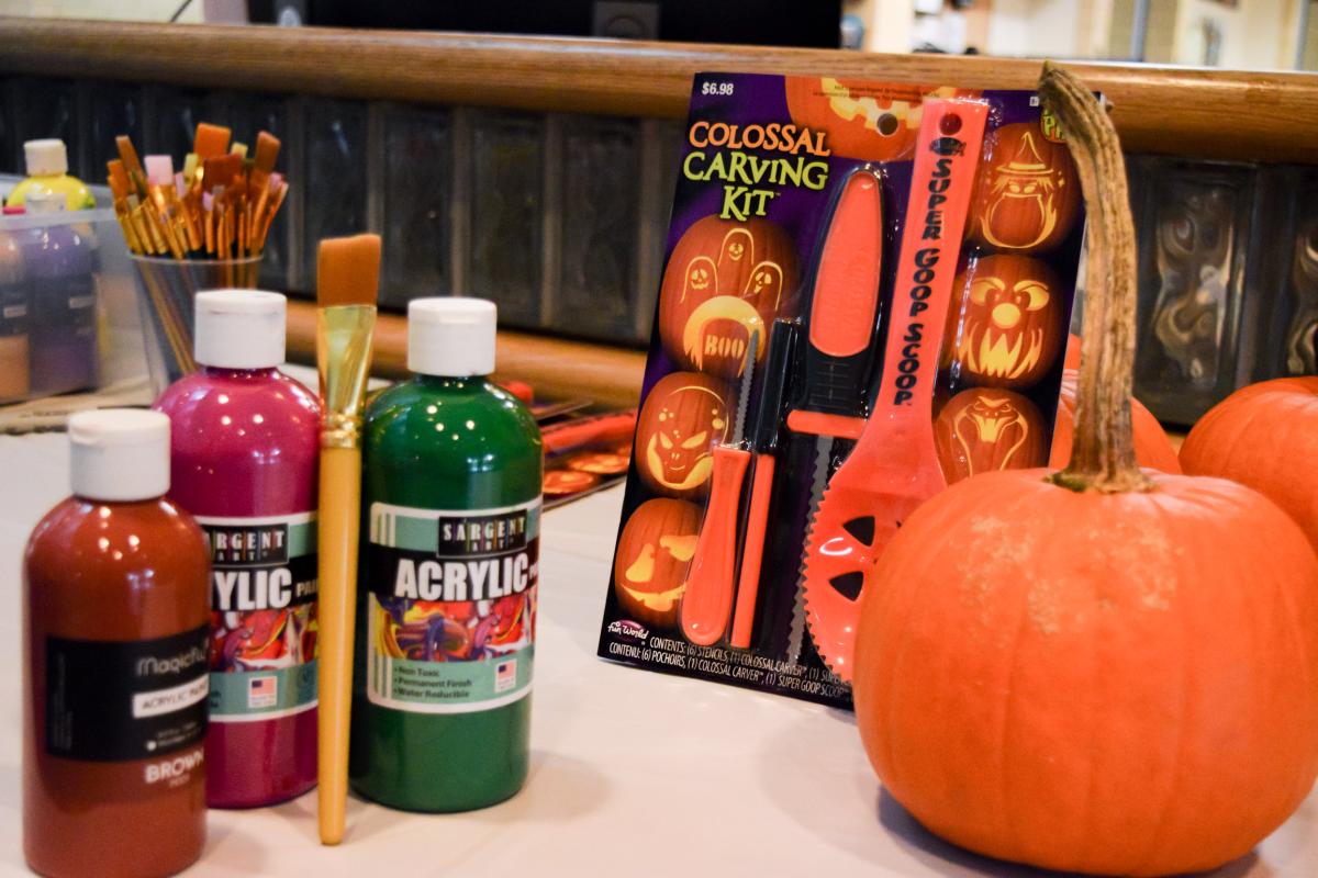 Carving kits and paint supplies help Fall Fest-goers personalize their pumpkins.