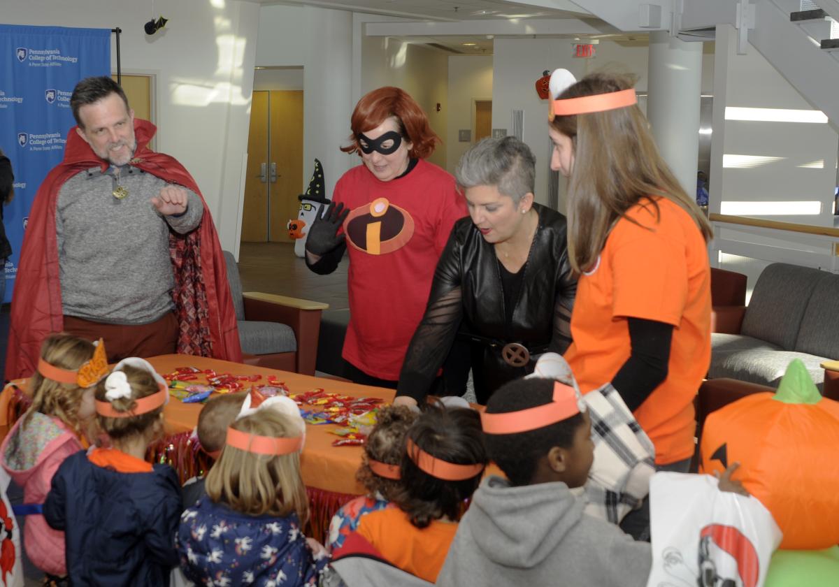 Childcare teacher Rebecca L. Helminiak (right) introduces her group to a costumed trio (whose real-life identities are Daniel J. Clasby, assistant dean of academic operations; Barbara J. Stevens, office assistant; and Tanya Berfield, director of student advocacy/Title IX coordinator).