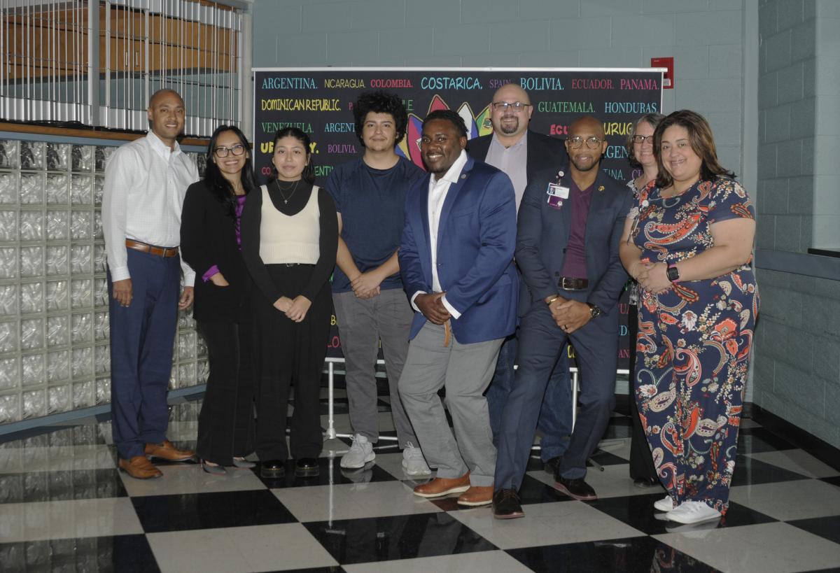 The day's speakers and co-sponsors of Tuesday's Hispanic Heritage Month event stand for a group photo in Penn's Inn.