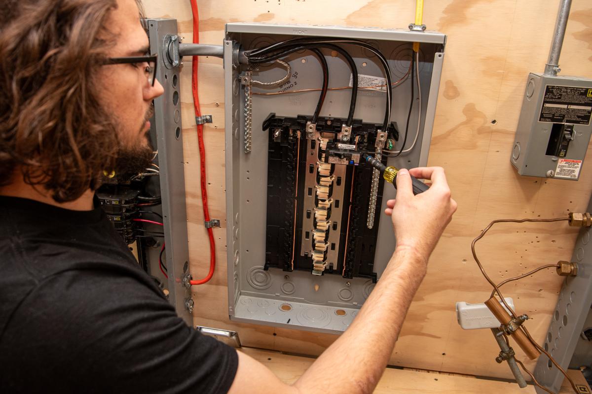 William D. Gesullo, an electrical technology student from Bridgeport, terminates the arc-fault circuit interrupter breaker. 