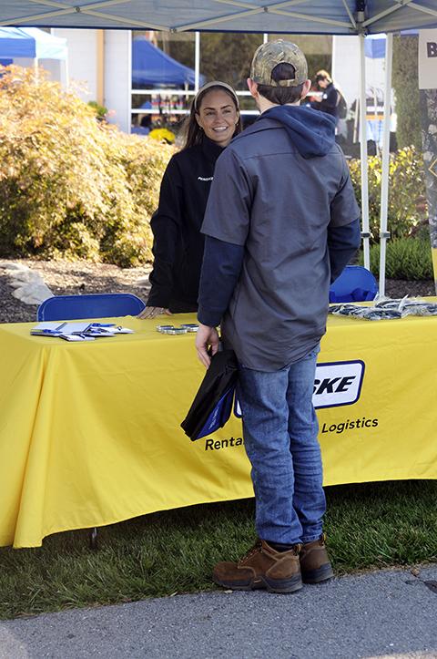  Eddie M. Vaks, of Lansdale, stops by the Penske tent for a chat with recruiter Gwenn Johnson. Vaks is enrolled in heavy construction equipment technology: technician emphasis.