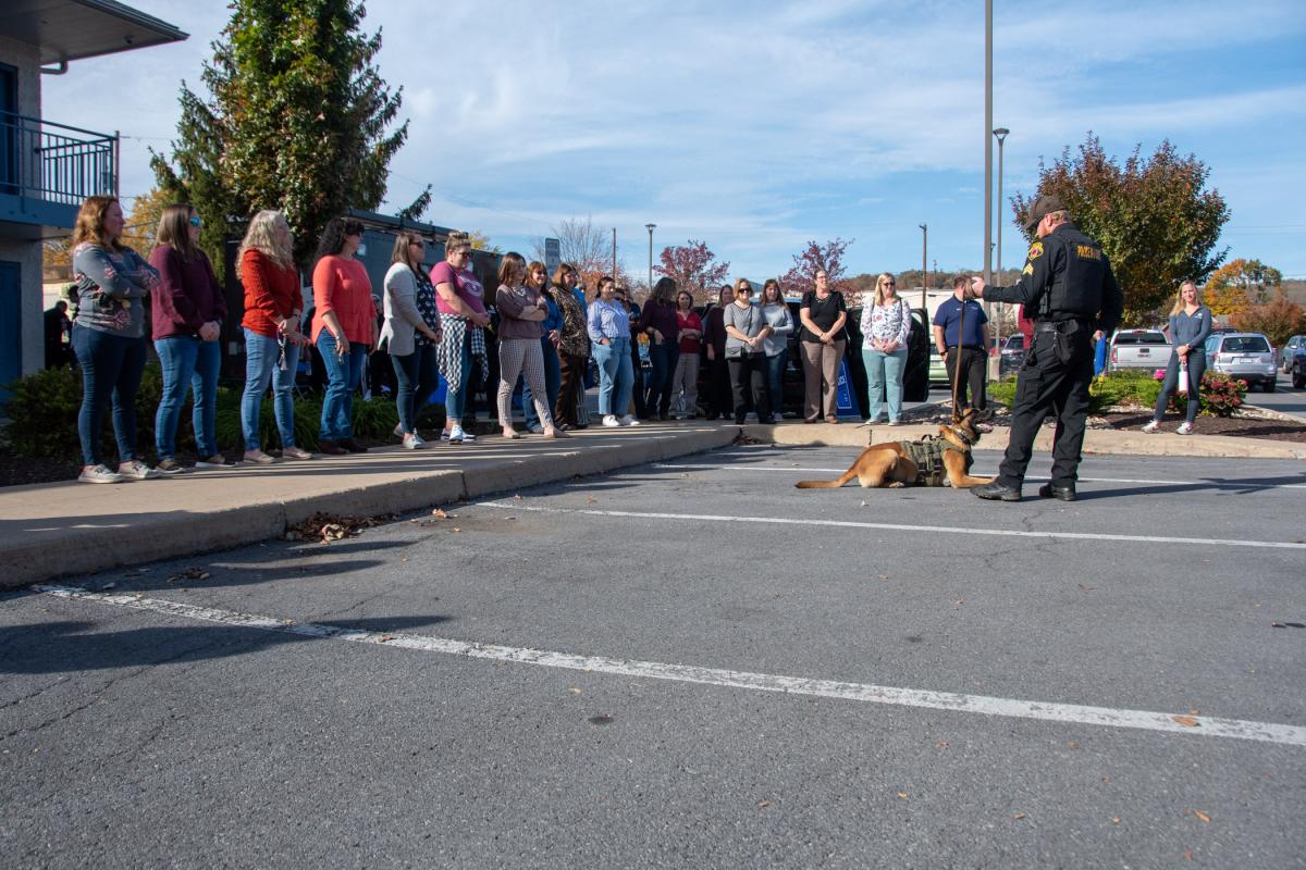 Nearly 30 employees gather as Williamsport Bureau of Police Sgt. Brian McGee tells them about the work of his partner K-9 Niko.