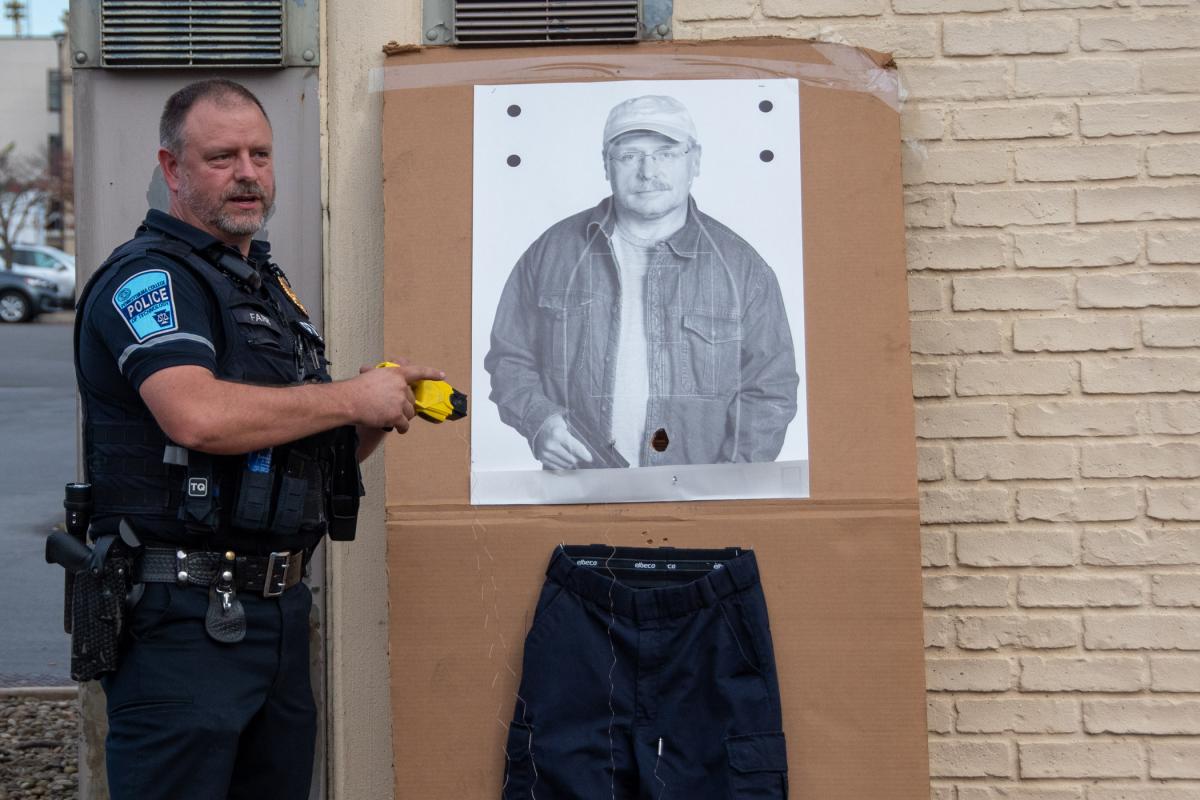 Lt. Fletcher W. Farr shows where barbs from his stun gun hit a target. 