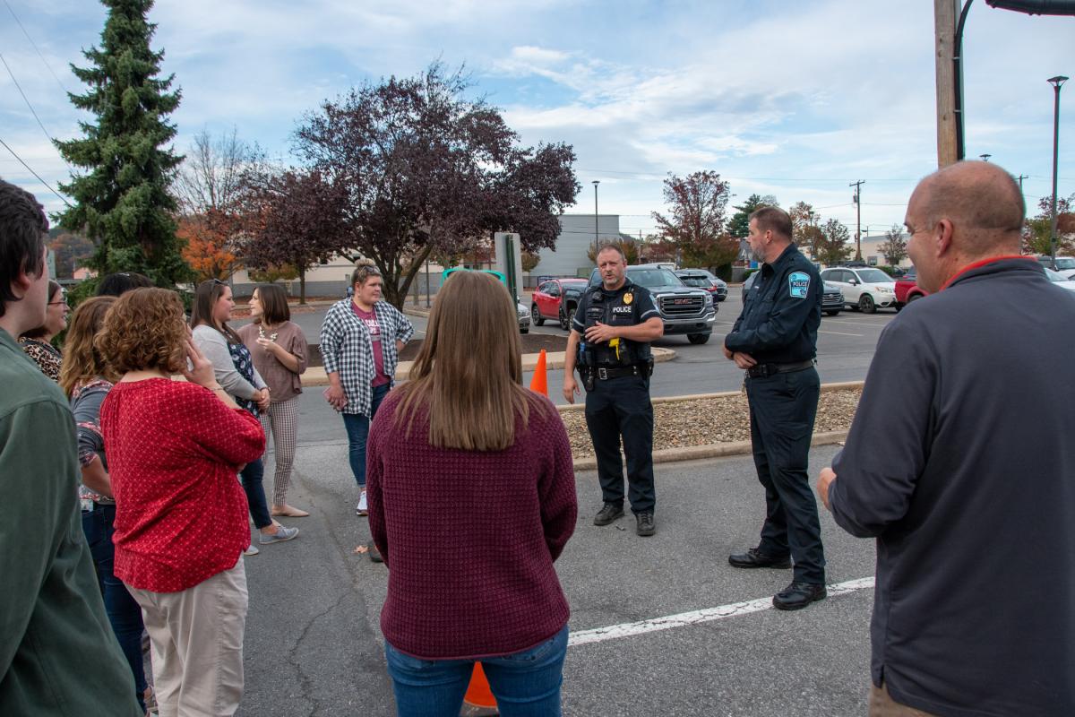 Farr and Officer Jeffrey E. Kriner address a group.