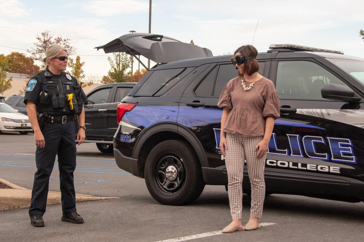 Madison A. Plesce, a generalist in the People & Culture Office, volunteers for a sobriety test, conducted by Officer Catherine J. Farr.