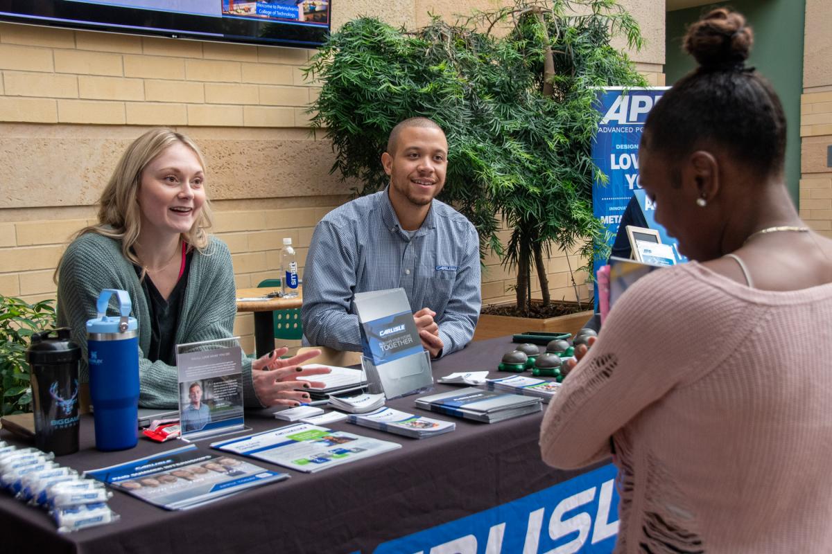 Alexis Hammons (left) and Noah Martin (center), of Carlisle Corp., talk with student Coryn A. Oswald, who is petitioned to graduate with a bachelor’s in plastics & polymer engineering technology in December. Martin completed a bachelor’s in plastics & polymer engineering technology from Penn College in 2018.
