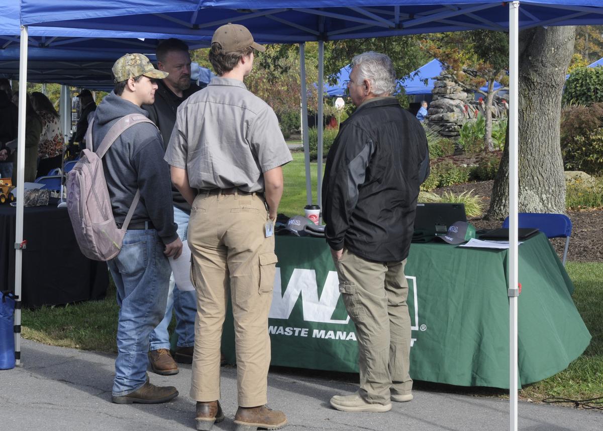 Potential technicians with Waste Management, among the companies that have risen to the Visionary Society level on the college's Donor Wall, interact with John Stanton (left background) and Kurt Albertson. 