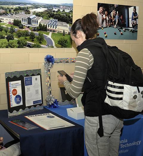 Megan R. Adams, an industrial design student from Carlisle and information desk assistant in the Office of Student Engagement, stops by a table in the CC lobby. On hand to help (but off-camera in this photo) was Savannah J. Zook, of Lewistown, a human services & restorative justice student and peer mentor.