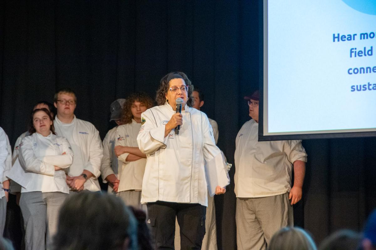 Chef Mary G. Trometter, assistant professor of hospitality management/culinary arts and instructor for the Introduction to Sustainable Food Systems course, addresses high schoolers.