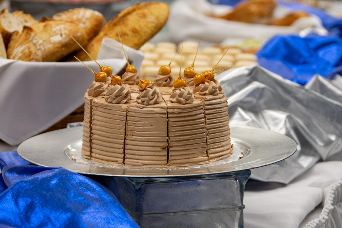 Candied hazelnuts top a mocha cake that is layered with Nutella Swiss buttercream and hazelnut praline.
