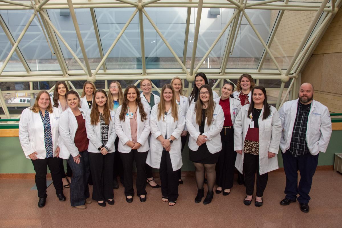 The bachelor’s degree nursing major’s December graduating class gathers during a break between poster presentations.