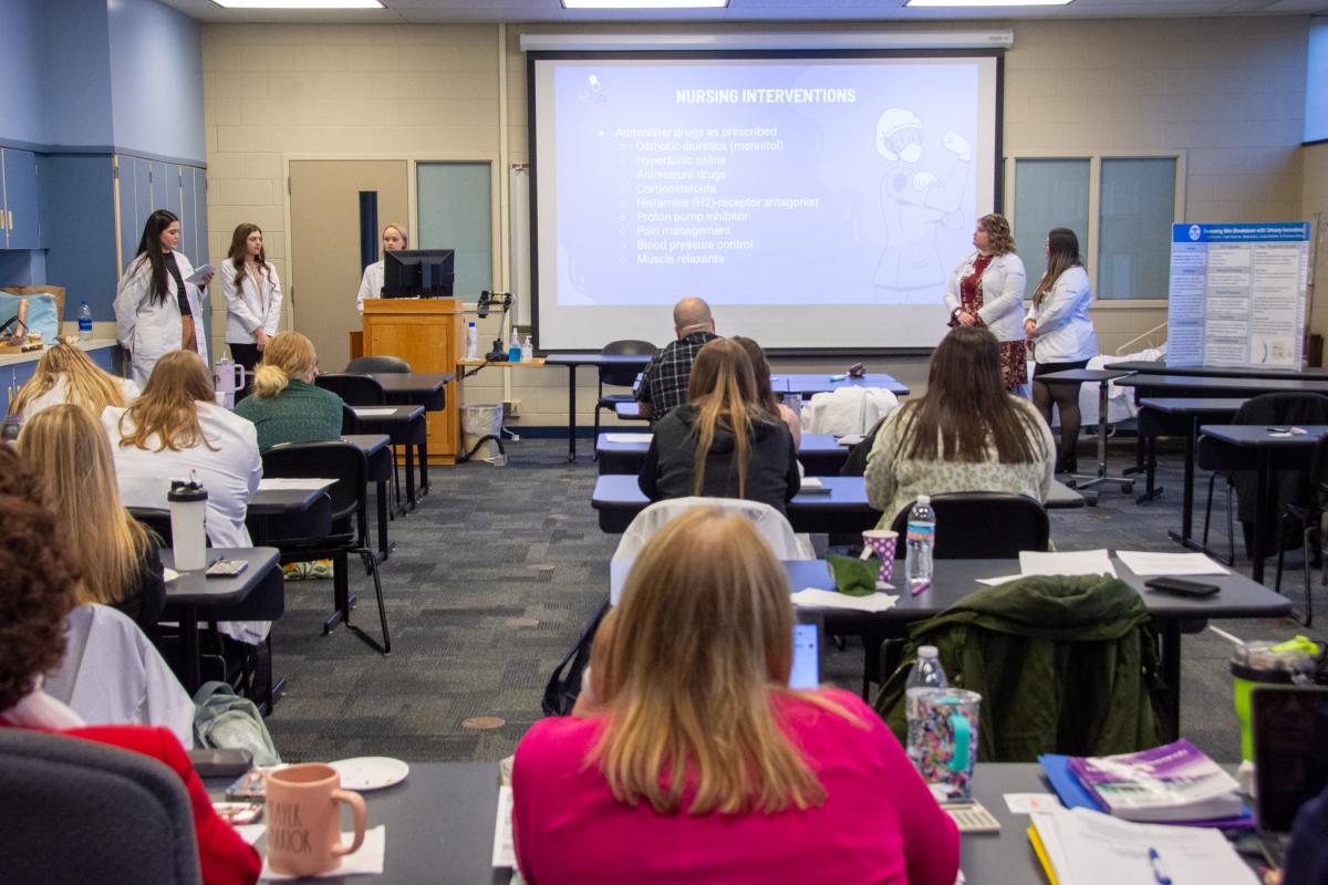 Davidson (left) details a case the students observed during their clinical experience.