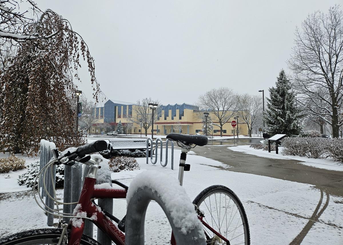 A campus commuter wasn't dissuaded by the morning powder, pedaling into a snow-capped bike rack outside the Davie Jane Gilmour Center.