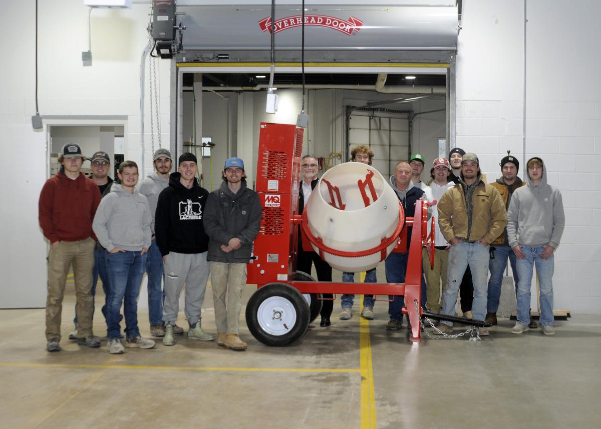 Students in a Concrete Construction course at Pennsylvania College of Technology surround a new mixer donated by Conewago Enterprises Inc. Flanking the equipment in the college's Construction Masonry Building are Chris Livelsberger (center, in glasses), Conewago human resources manager; and Franklin H. Reber Jr., instructor of building construction technology at the college.
