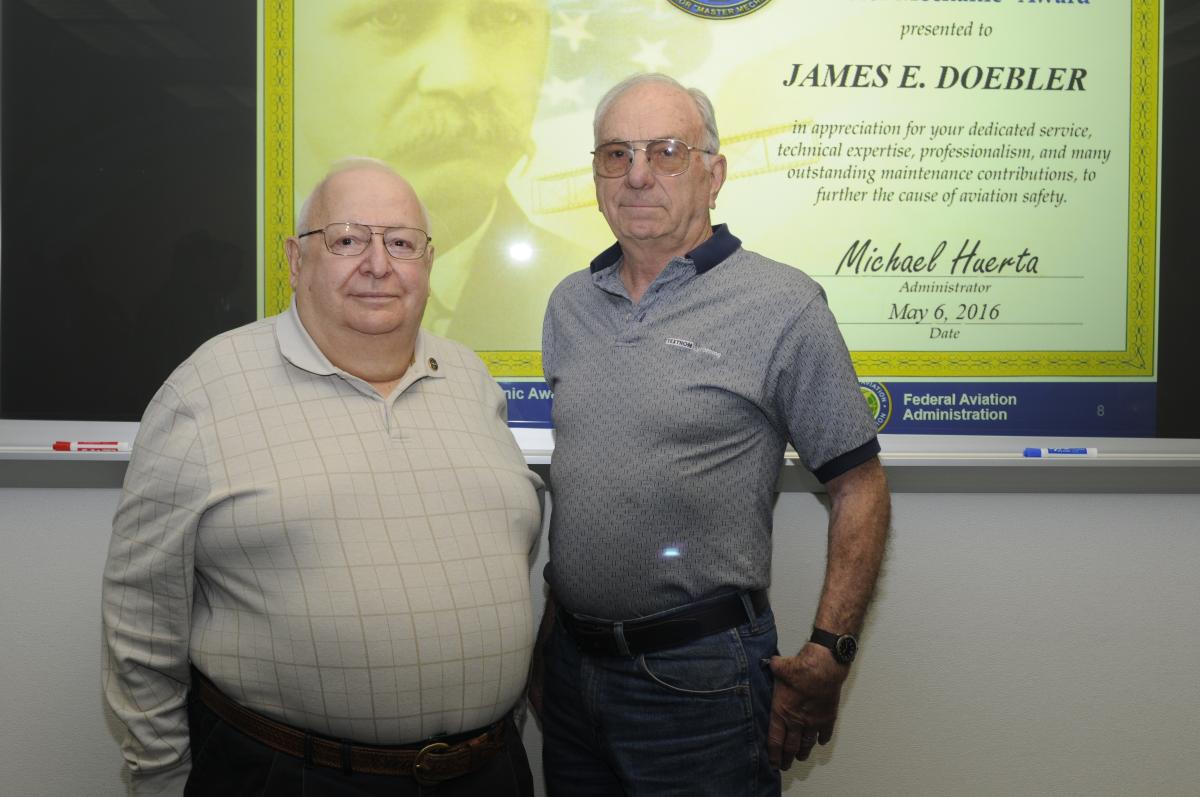 Doebler shares a moment with fellow retiree Robert M. Werkmeister Sr., who was presented with Charles Taylor Master Mechanic honors in 2006 ...