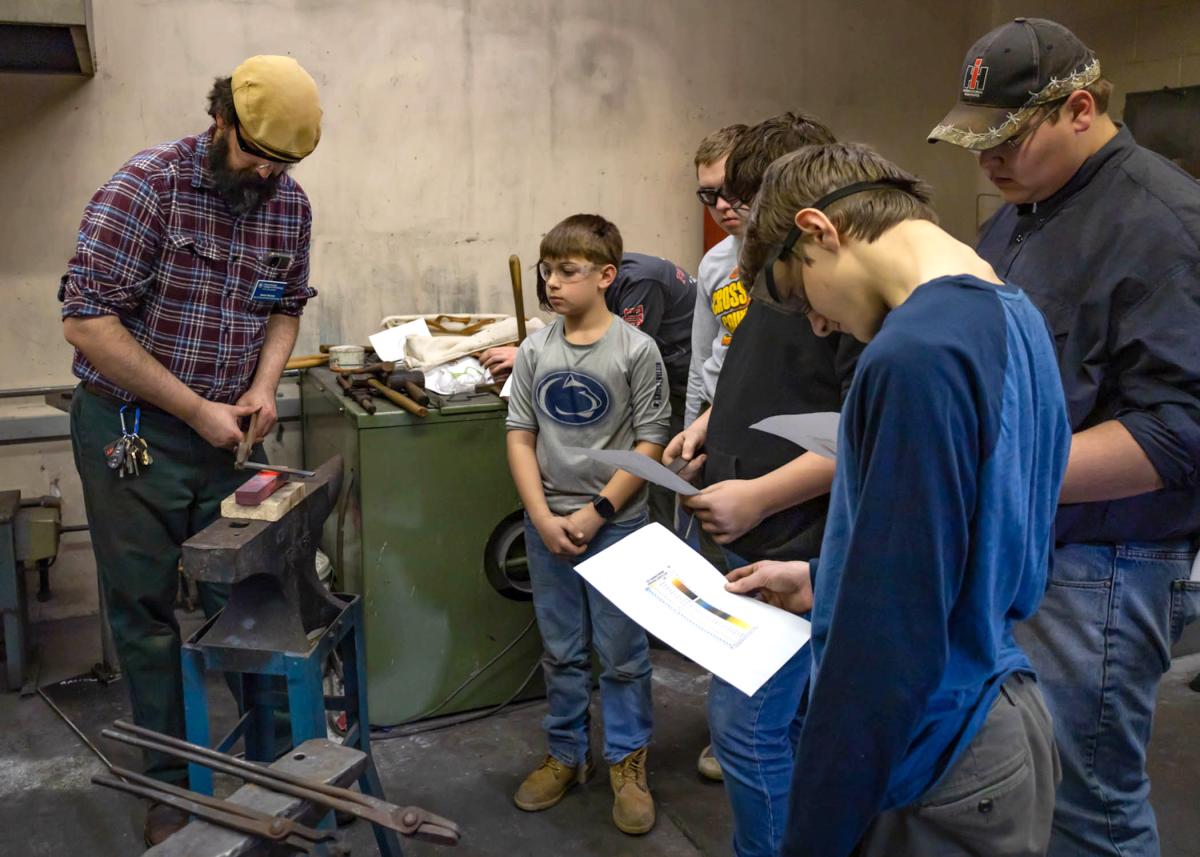 Pennsylvania College of Technology’s Daniel Ravizza, a CNC machining and automation faculty member, demonstrates how to temper a center punch during last year’s Merit Badge College for Scouts. The college is hosting the 2024 event on Feb. 17. Scouts can earn up to three merit badges that day.