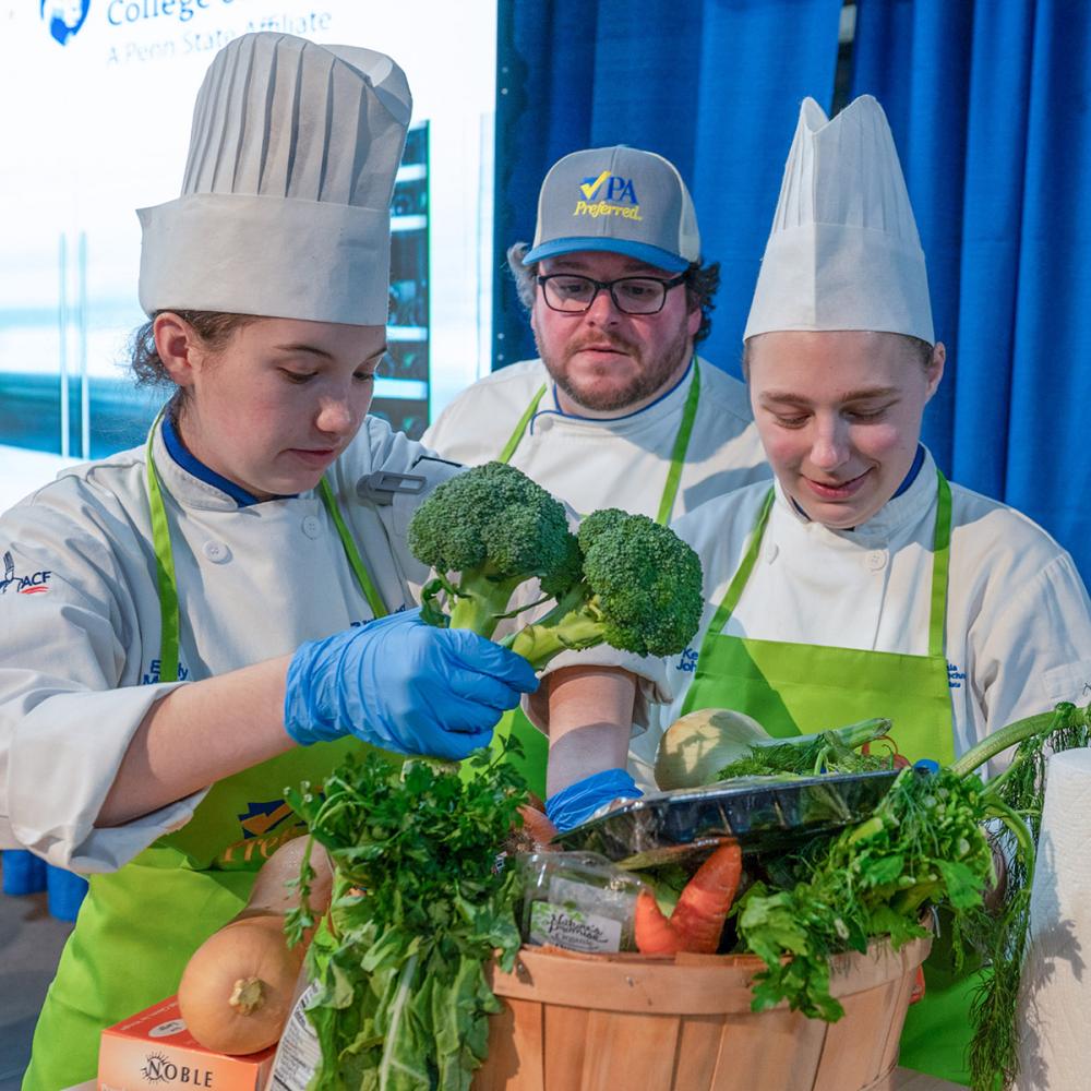 chef and two students at work at last year's Farm Show