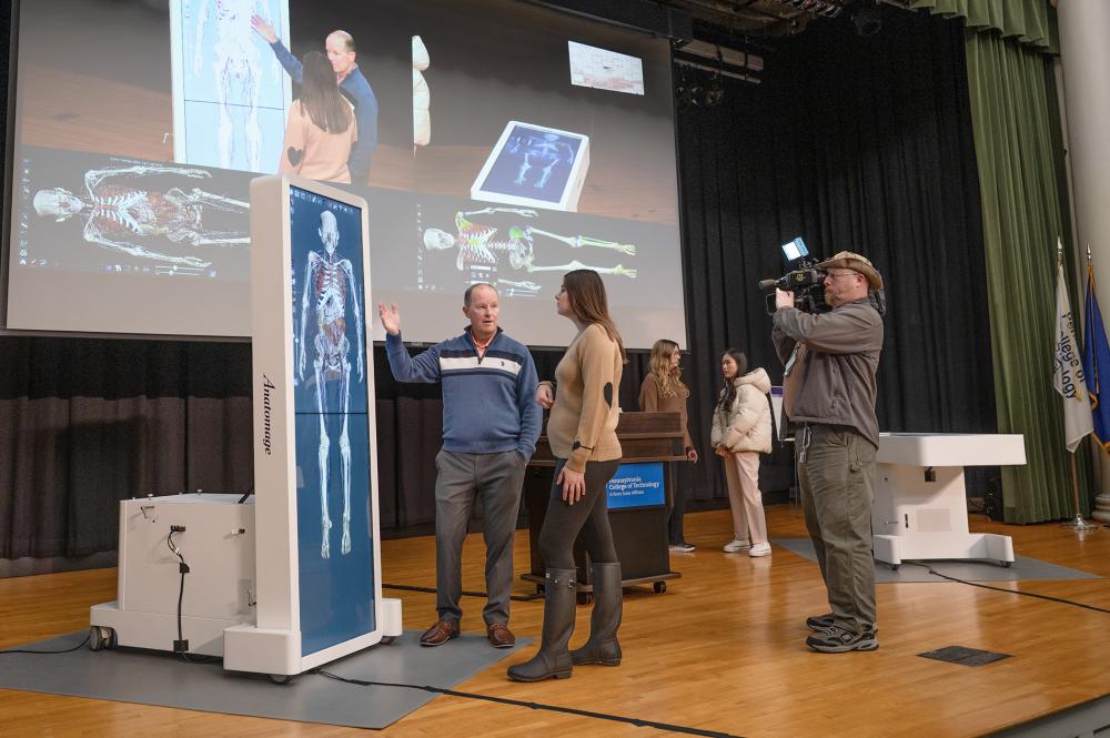 people on stage with anatomy tournament equipment