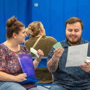 Assessing their assignments and finances are Penn College alumni and GEO Reentry Services staff Elena L. Girio (left), case manager, and Nick W. Henning, reentry coordinator. Girio earned an applied human services degree in 2020, and Henning graduated in 2022 in human services & restorative justice. 