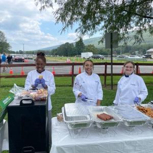 Plating hot dogs and chicken tenders are (from left) Green, Donnie and Sollenberger.