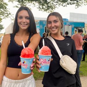 Pre-dental hygiene students Kaylee L. Snyder (left), of Honey Brook, and Meg R. Agan, of Elmira N.Y., indulge their collective "sweet tooth" following a visit to the Pelican's Snoballs food truck.