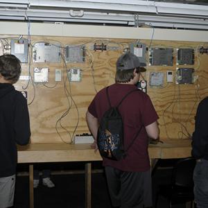 Students from Admiral Peary AVTS use their smartphones as electrical controllers in Zimmerman's lab.