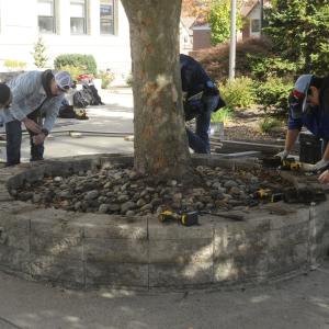 One crew completes removal of rotten boards from one of the seating areas ...