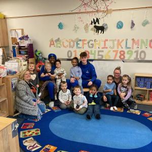 Hayes (rear left) and Bost share their time – and their laps! – during preschool storytime. Hayes, of Chesapeake, Va., is an electronics & computer engineering technology student; Bost, from West Nottingham, N.H., is enrolled in construction management.