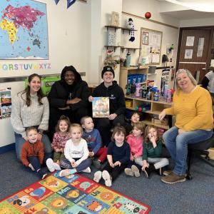 Brown (center left), of Bridgeport, Conn., and Chandler, of Norfolk, Va., join children and staff for a reading of "Santa's Eleven Months Off." Brown is pursuing a degree in business administration: sport & event management concentration; Chandler is an engineering design technology student.