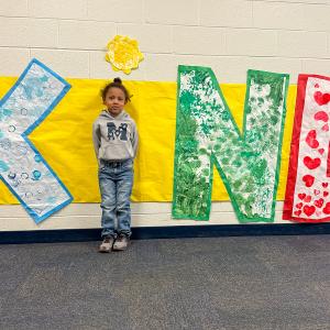 child at Kind sign