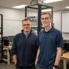 Stephen R. Cheskiewicz, associate professor of computer information technology, joins 2019 grad Anthony S. Riegel in the college’s recently updated networking lab before Riegel offered real-world perspectives to students in a capstone class.