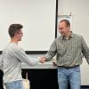 Award-winning student Nathan Totsky is congratulated by Kevin Yokitis, assistant professor of electrical technology/occupations.