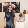 Alexis M. Burrell, of Danville, a senior in graphic design at Pennsylvania College of Technology, is seen in the lobby of The Gallery at Penn College, where her ceramics and photography exhibit – “Moving the Earth, Capturing the Sun” – is on display. 