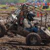 Pennsylvania College of Technology’s Isaac H. Thollot drives the school’s all-terrain vehicle through the mud at Baja SAE Oshkosh in Wisconsin. The Penn College entry finished 10th out of 57 cars in the four-hour endurance race. The Baja SAE club has existed at Penn College for 18 years, but this was the first time the team had to build a four-wheel-drive car for the competition. (Photo by Casey B. Campbell) 