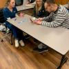 A Hope Enterprises client (in striped shirt) practices brushing after instruction by Gabriella R. Donato (left), of East Berlin, and Jerzey R. Hagen, of Johnstown.