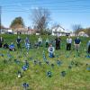 Following the planting of 500 pinwheels in a field next to the Old Lycoming Township Volunteer Fire Co., participating community members and representatives from Pennsylvania College of Technology’s Human Services and Restorative Justice Club, Old Lycoming Township Police Department, Lycoming County Children & Youth Services, Tiadaghton Valley Regional Police, and Pennsylvania State Police Troop F pose for a photograph.