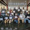 Holding their Aircraft Electronics Association certificates at Pennsylvania College of Technology's Lumley Aviation Center are 15 of the 18 students recently certified in wiring inspections.