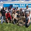 Members of the Penn College team proudly pose with their car after finishing fifth out of 107 schools in the four-hour endurance race at Baja SAE Kansas. 