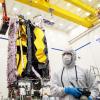 Pennsylvania College of Technology graduate Christopher J. Herzog, of Mechanicsburg, is a photographer for Northrop Grumman at its Space Park in Redondo Beach, Calif. Behind Herzog is a portion of the James Webb Space Telescope, one of many aerospace achievements that he documents with his camera. 