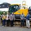 Gathering around a Volvo EC220 excavator on loan for Pennsylvania College of Technology students’ use