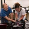 Paul W. Albright, instructor of manufacturing engineering technology at Pennsylvania College of Technology, assists Suzanne Mayberry, a teacher from the Mahanoy Area School District, with her desktop computer-numerical-control machine.