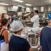 Dining Services' Christopher R. Kelley dazzingly amuses his audience in an exhibition of dough-tossing.