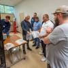 Guest instructor Mark Strachan (second from left), a nationally recognized industry expert, and workshop participants assess product as it rolls off the thin-gauge thermoforming equipment in Pennsylvania College of Technology’s Plastics Innovation & Resource Center. 