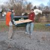 Adam C. Swan and R. Quinn Ross move plywood out of the wintry weather.