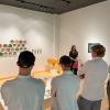 Penny Griffin Lutz, gallery director, speaks with students about the materials and meaning behind Anna Metcalfe’s “Pop Up Pollinator Picnic,” 2016-21.