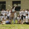 Teens don their PFEW T-shirts and gather outside the ACC for company photos with their adult business mentors.