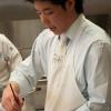 Alan Budiman, of CalJava International, demonstrates coloring a gum-paste flower with luster dust during a demonstration for students in the Introductory Baking course. He is the son of Daniel Budiman, who conceived the contest.